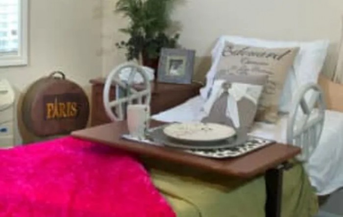 A cozy seating area with decorative elements including a pillow, tray, and photo frame.
