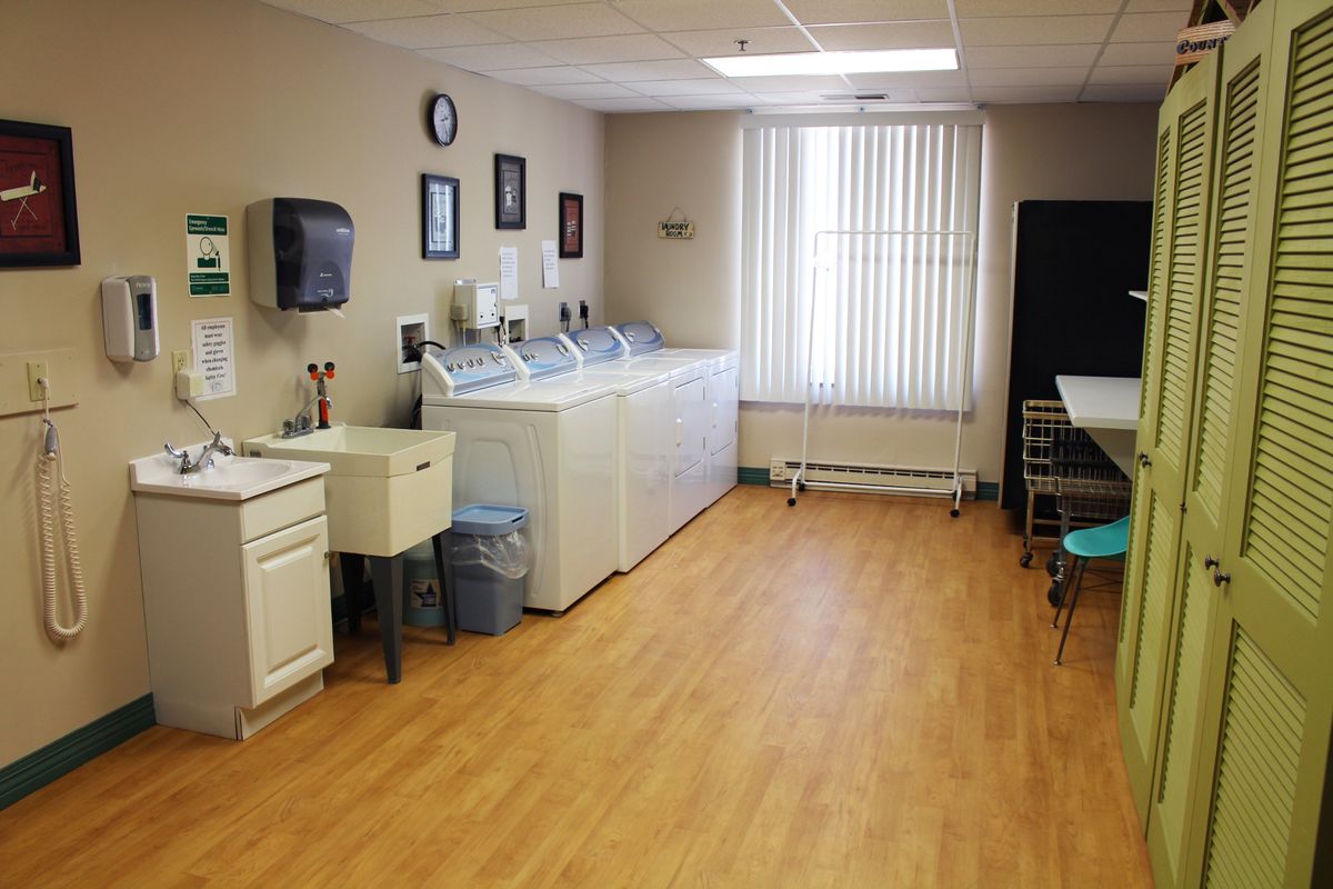 A well-organized laundry room with washing machines and a sink.