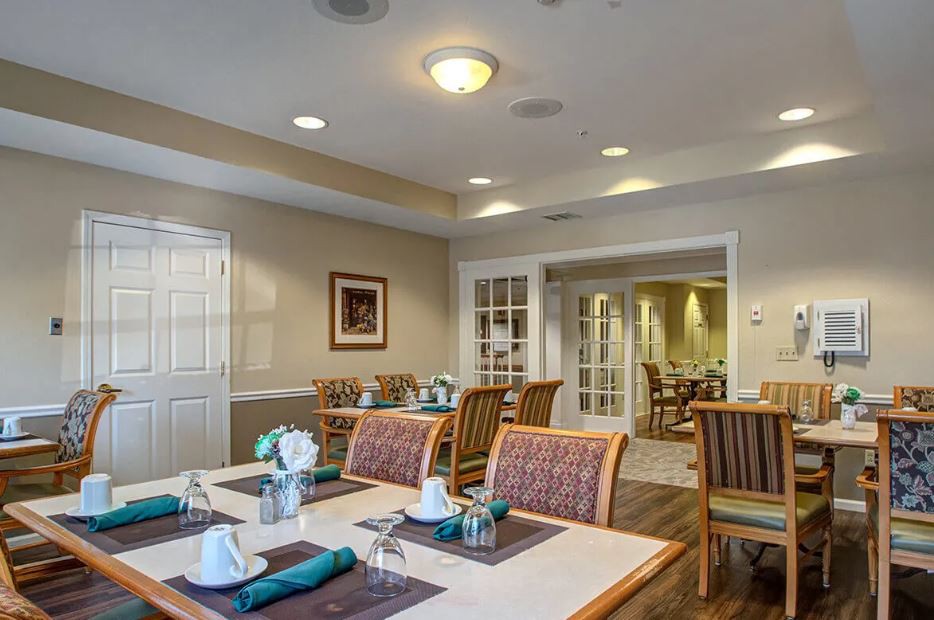 A cozy dining area with neatly arranged tables and chairs, ready for guests.