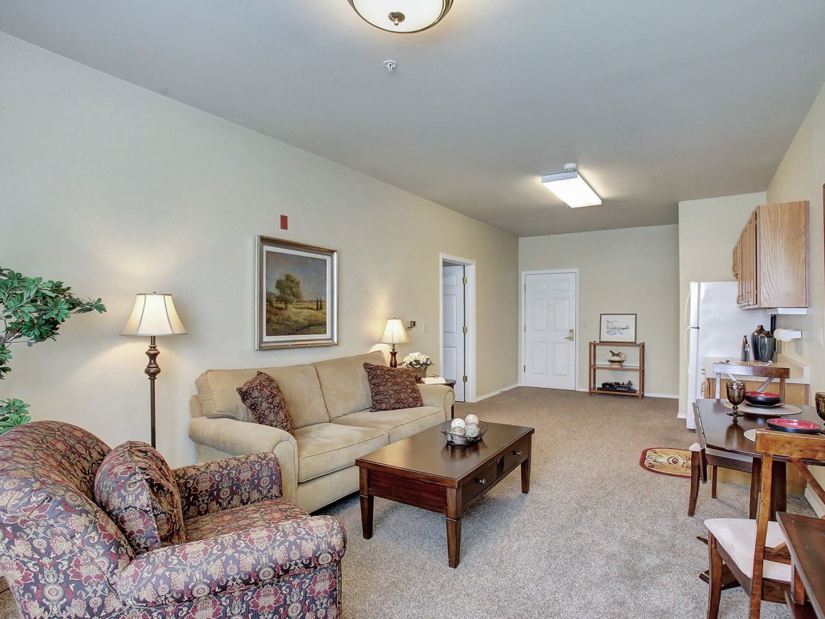 A cozy living room with a sofa, coffee table, and lamps.