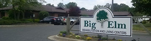 Entrance to a rehabilitation facility with a sign displaying its name.