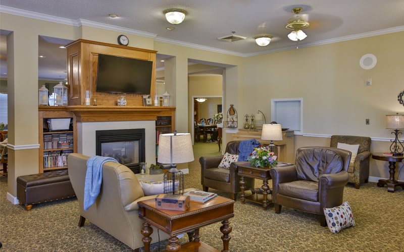 A cozy living room with a fireplace, television, and comfortable seating arrangement.
