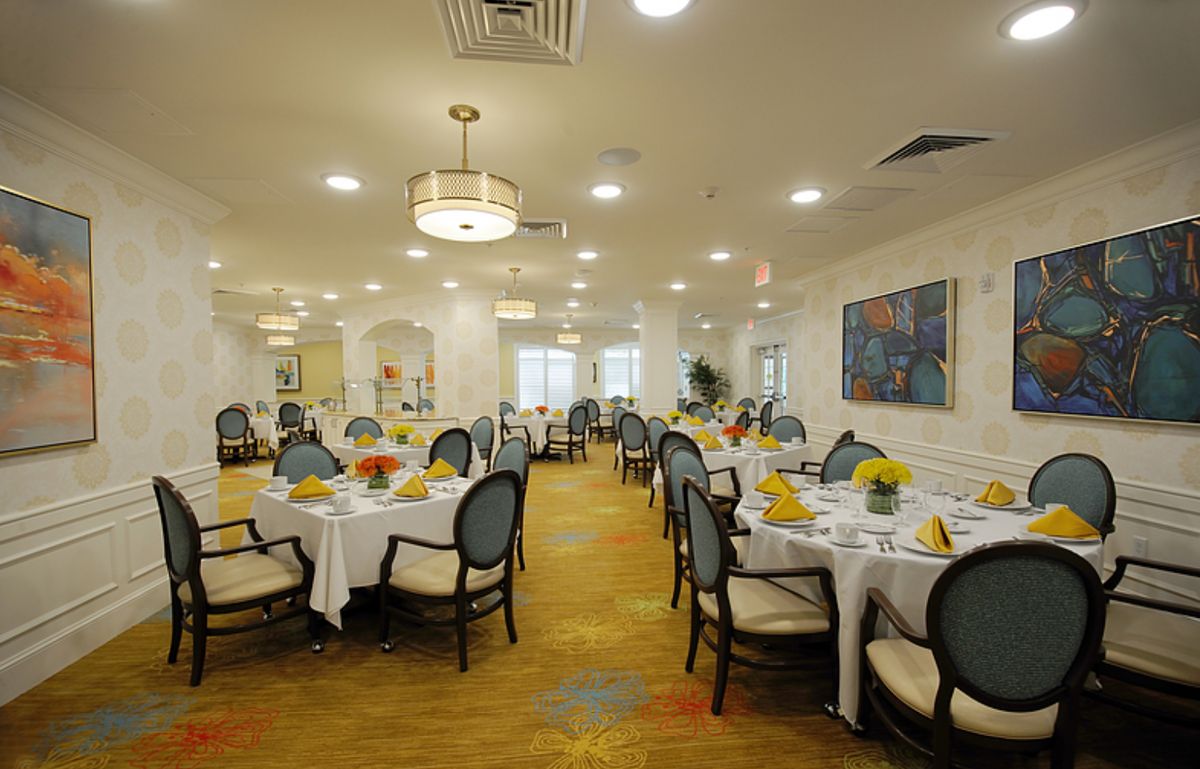 An elegantly decorated dining room with neatly arranged tables and chairs.