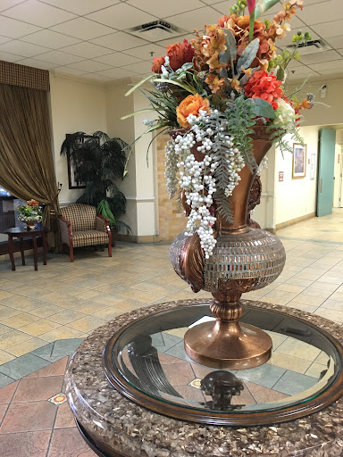 A beautifully arranged floral centerpiece in a welcoming lobby space.
