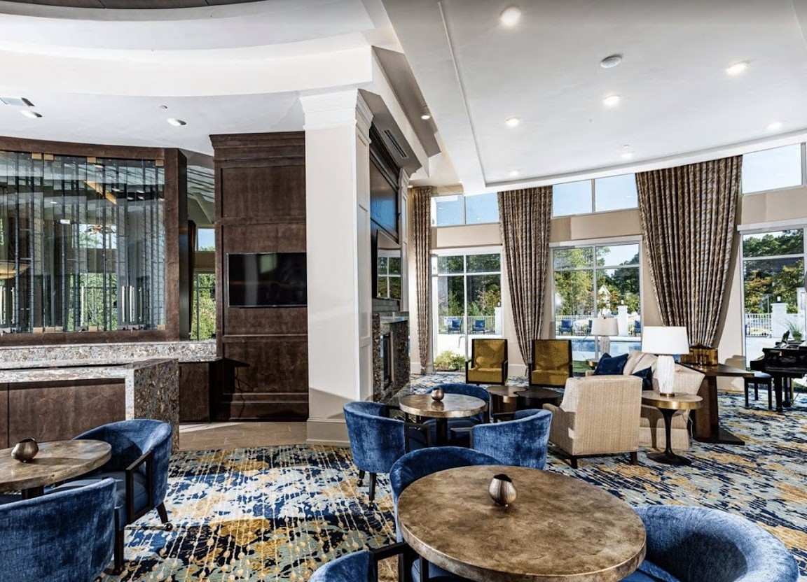 A luxurious hotel lounge with modern furniture and natural lighting.