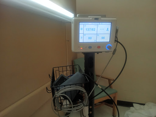 A blood pressure monitor displayed in a clinical environment, ready for patient use.