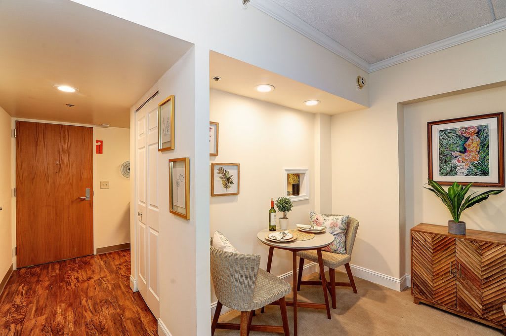 Cozy dining nook in a well-decorated apartment with wood flooring and ambient lighting.