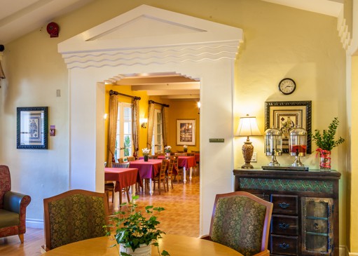 A warmly lit dining room with elegant decor and furnishings.