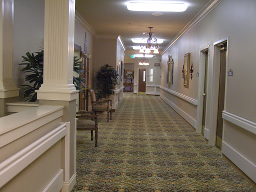 A well-lit hallway featuring decorative elements and comfortable seating.