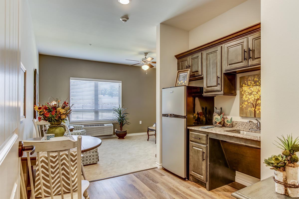 A modern apartment interior featuring a compact kitchen and cozy living space.