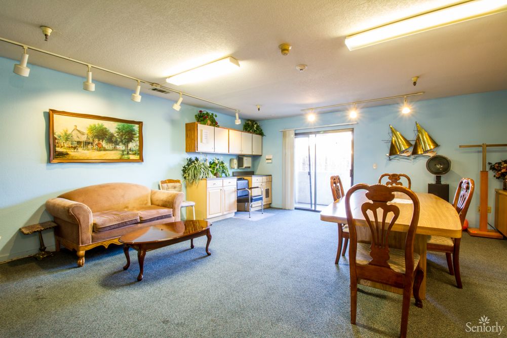 A cozy living and dining area with classic furniture and decorative elements.