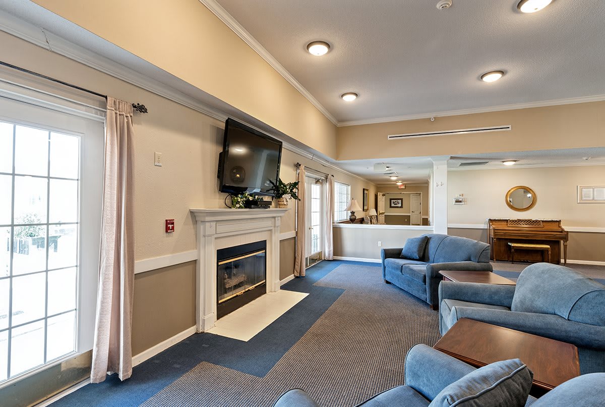 A cozy living room with a fireplace, TV, and comfortable seating.
