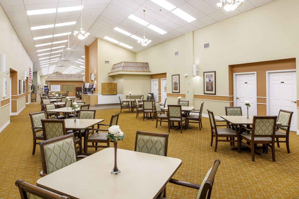An empty and spacious dining area with neatly arranged tables and chairs.