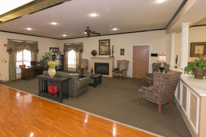 A spacious living room with comfortable seating and a fireplace.