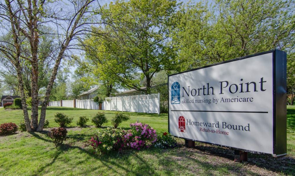 A community sign for North Pointe surrounded by trees and landscaping.