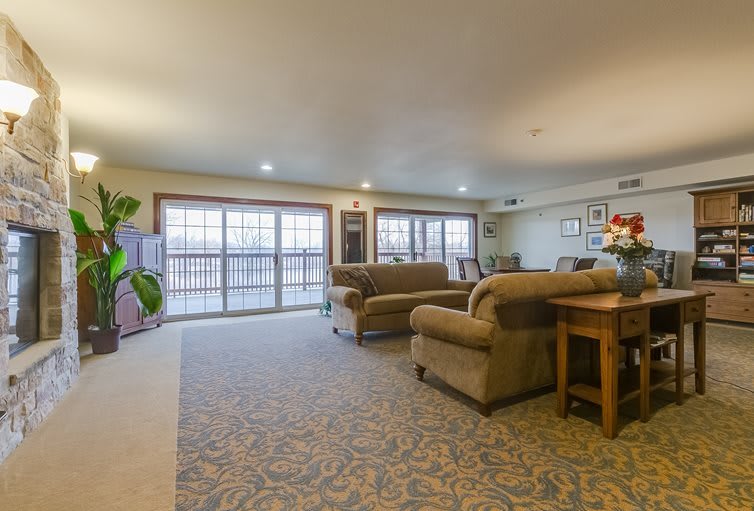 A spacious living room with comfortable sofas and large windows.