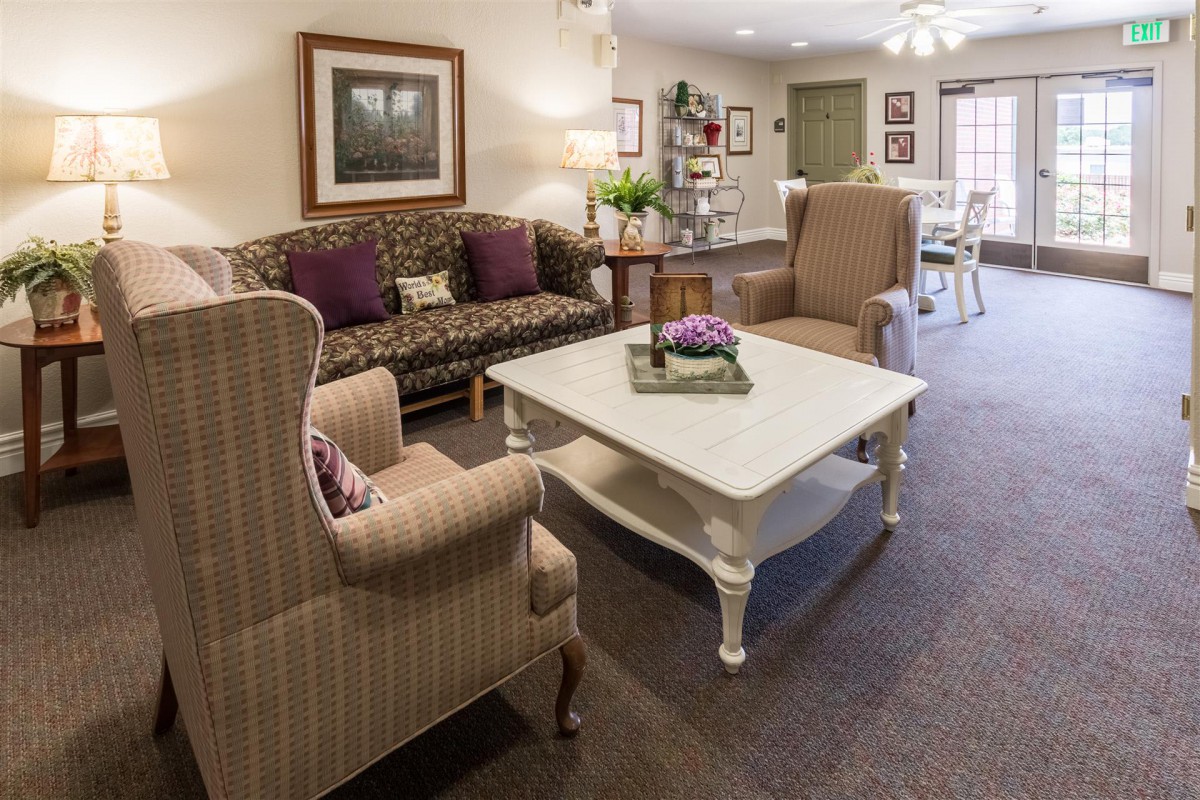 A cozy living room with a sofa, armchairs, and a coffee table.