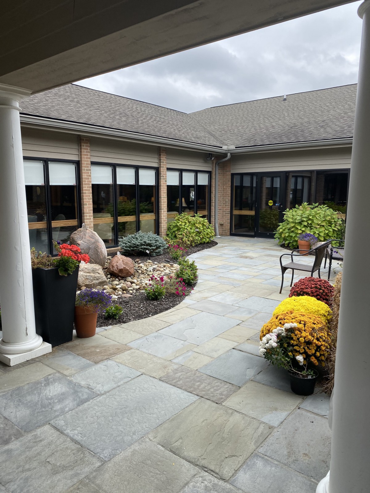 A beautifully landscaped courtyard with a variety of plants and outdoor seating.