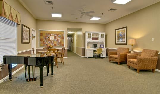 A cozy living room with a piano and comfortable seating.