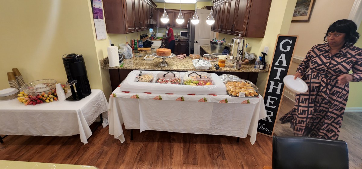 A kitchen setup with a buffet table filled with various dishes, prepared for a party or gathering.