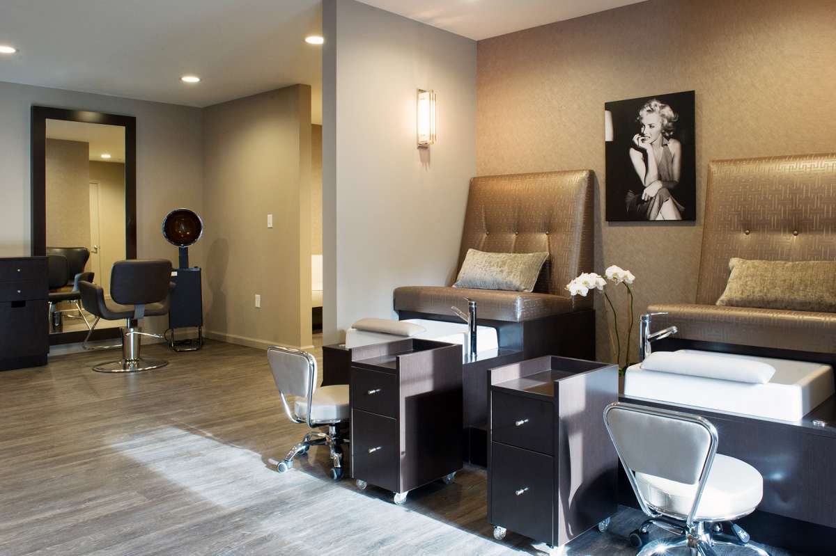 A modern spa salon with a pedicure station and stylish interior design.