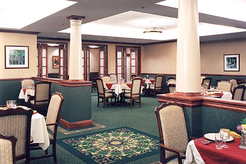 A well-decorated restaurant dining area with tables and chairs arranged neatly.