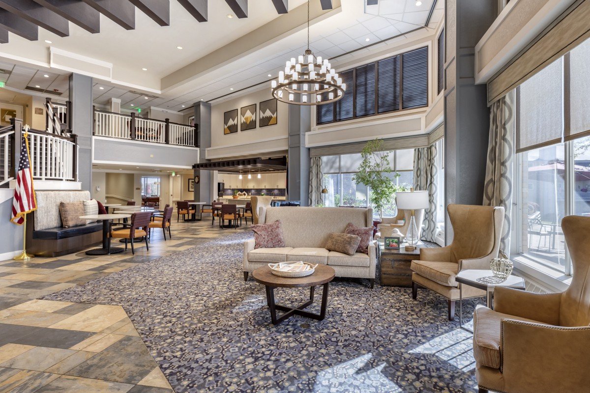 A modern and spacious hotel lobby with elegant furniture and abundant natural light.