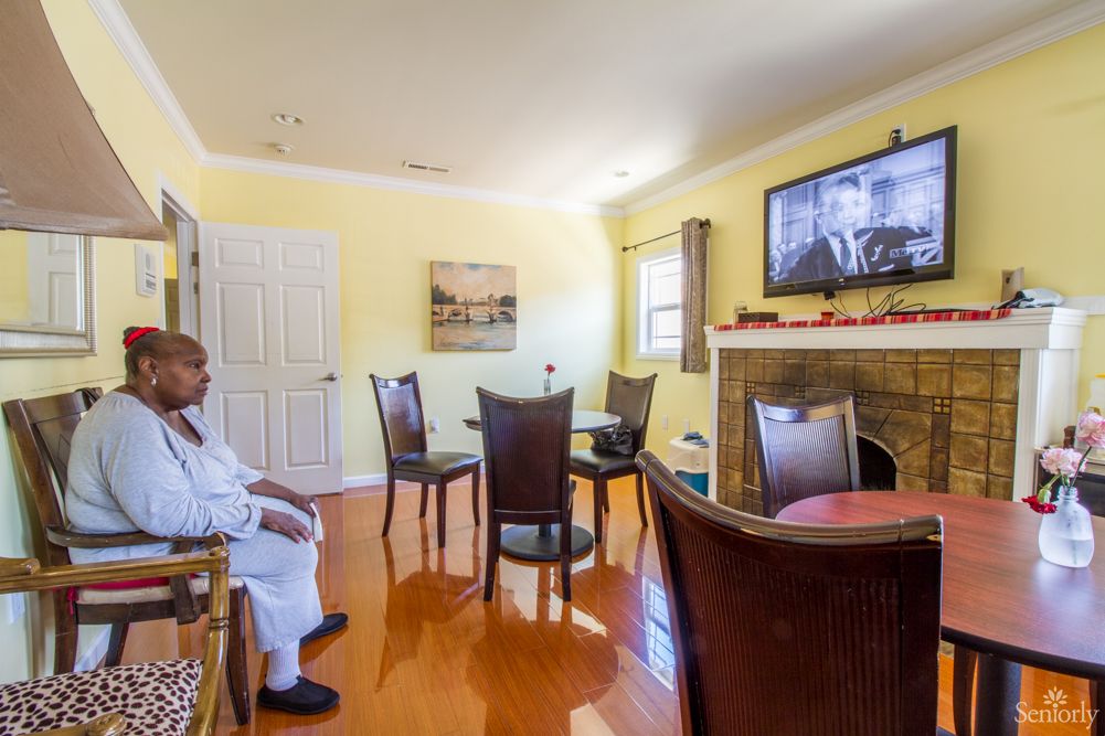 A person sitting in a cozy living room watching television.