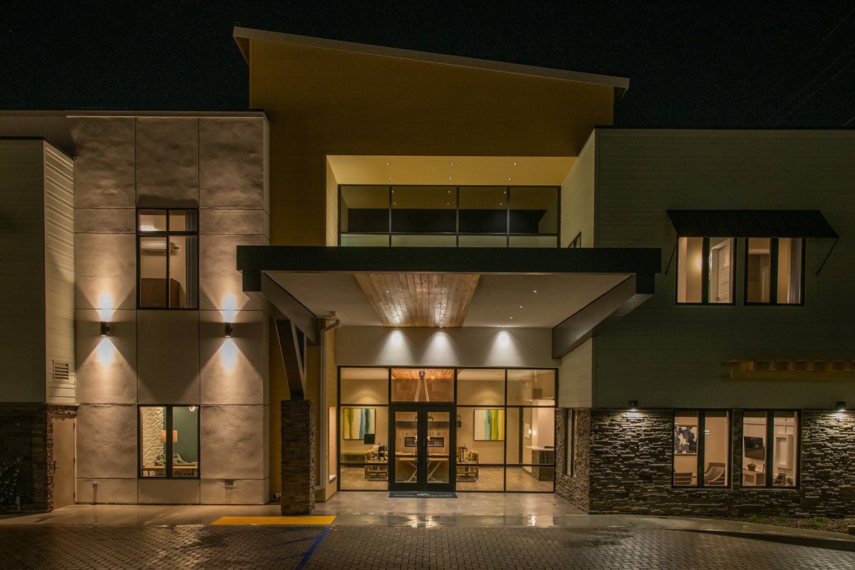 A modern building entrance illuminated at night.