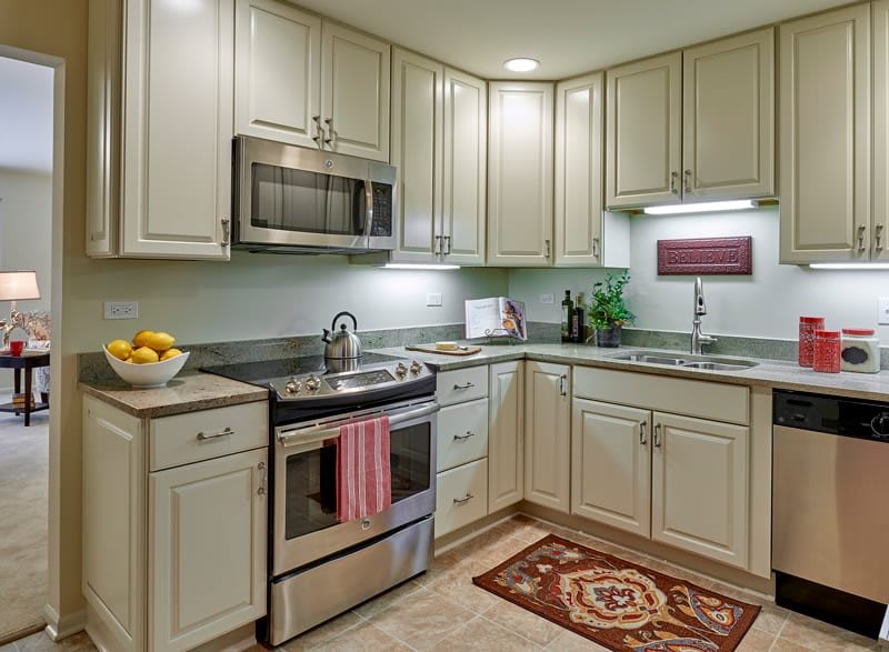 A modern kitchen with stainless steel appliances and light-colored cabinetry.