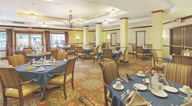 A spacious dining area with neatly arranged tables and chairs, showcasing elegant interior design.