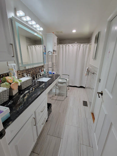 A stylish and modern bathroom featuring a sleek vanity, elegant lighting, and a clean shower area.