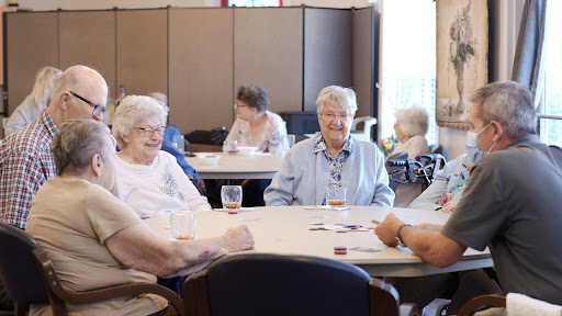 Seniors enjoying a game and each other's company at a community center.