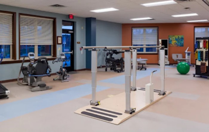 An indoor physical therapy and rehabilitation room equipped with exercise equipment.