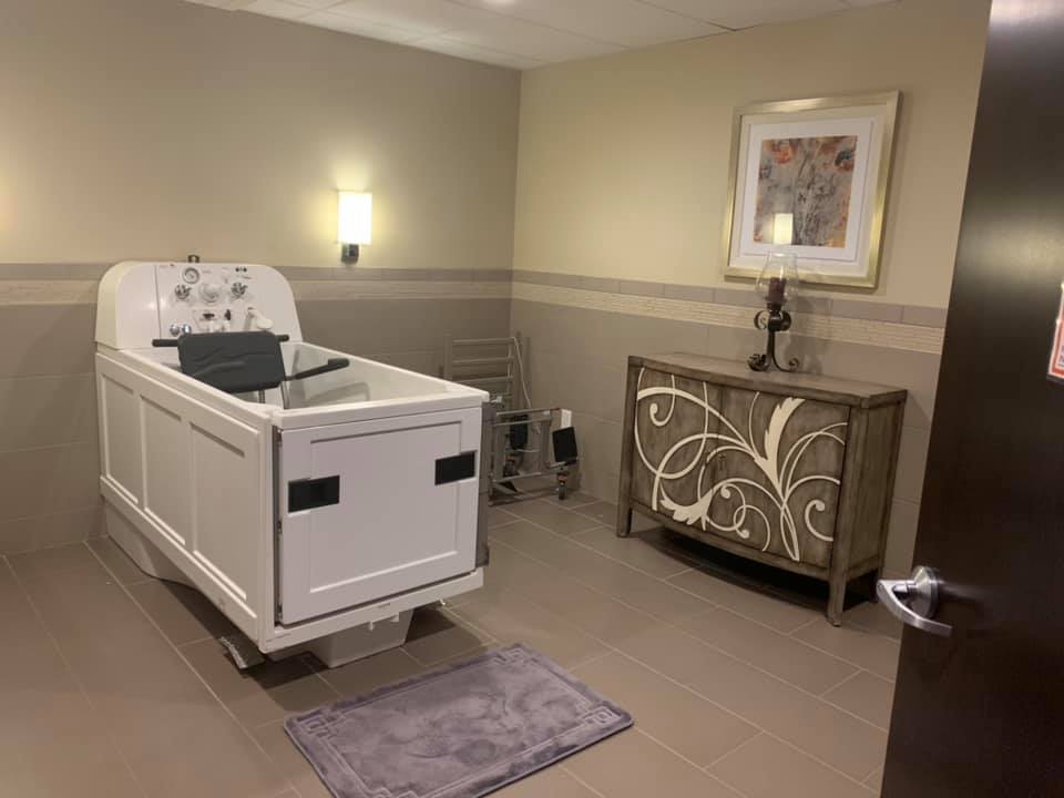 A serene room in a funeral home with a casket and elegant decor.
