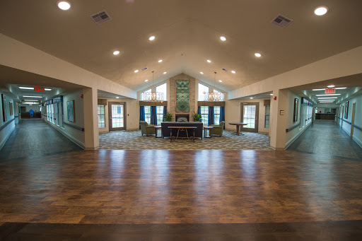A spacious and well-lit interior room with modern decor and wooden flooring.