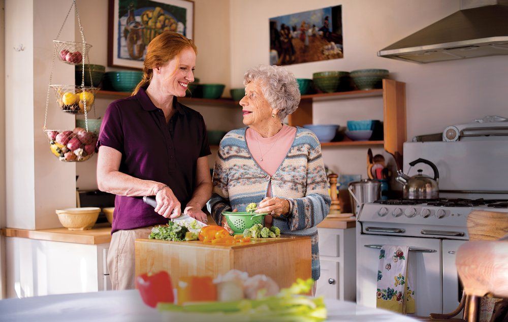 Two people enjoying cooking together in a home kitchen.
