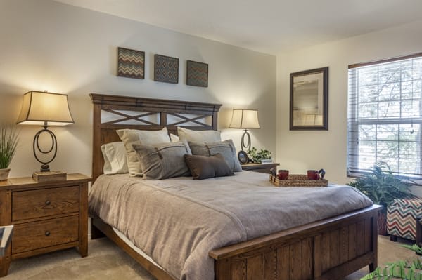 A warm and inviting bedroom with stylish decor and comfortable bedding.