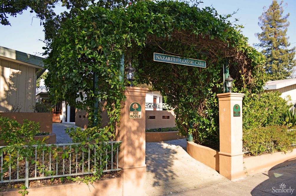 A charming entrance adorned with greenery leading to a building.