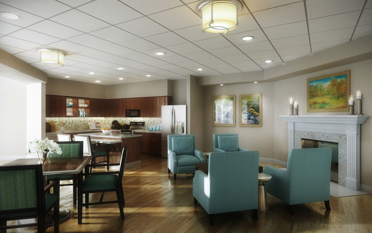 A modern open-concept living space featuring a seating area and kitchen with stylish furniture and lighting.