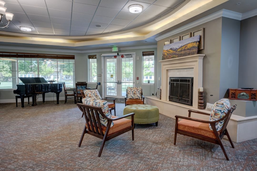 A cozy and elegant living room with a fireplace and seating area.