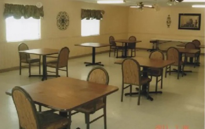 An empty dining room with tables and chairs neatly arranged.