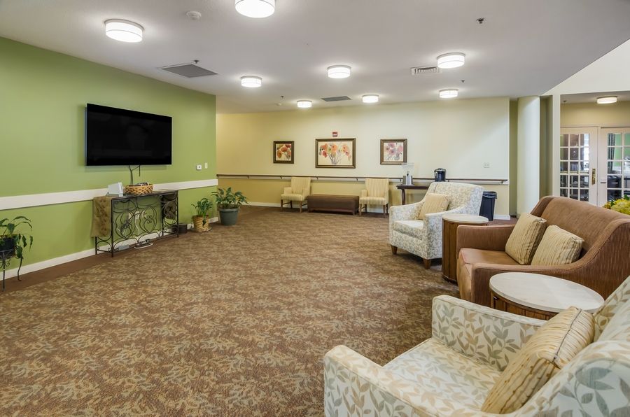 A spacious and comfortable living room with modern furniture and a large TV.