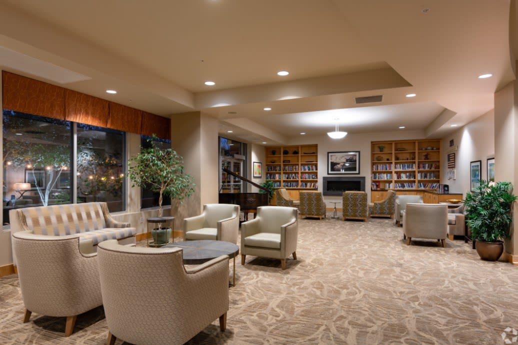 A cozy lounge area with comfortable seating and bookshelves.