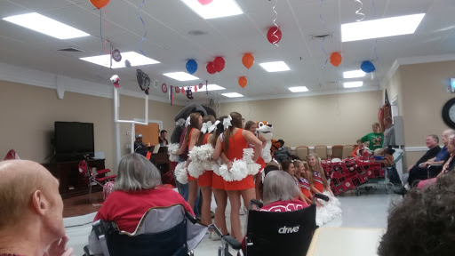 Cheerleaders performing during a community event with festive decorations.