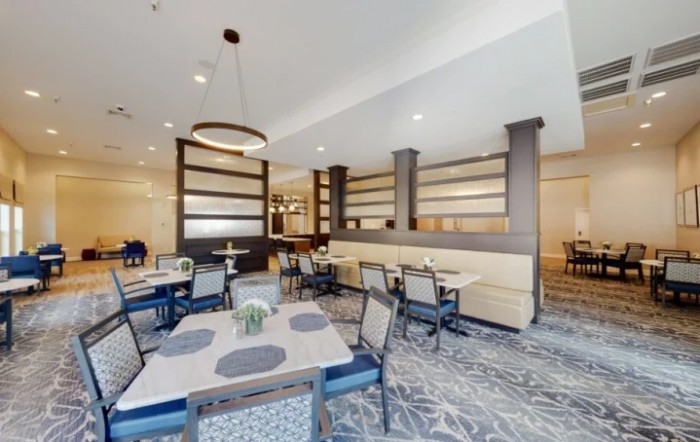 A modern dining area with neatly arranged tables and chairs, featuring stylish interior decor.