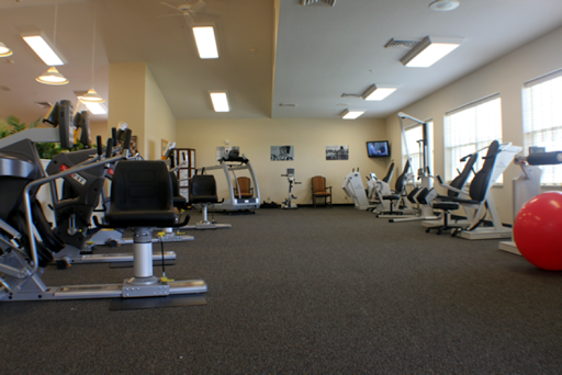 A spacious gym area equipped with various exercise machines.