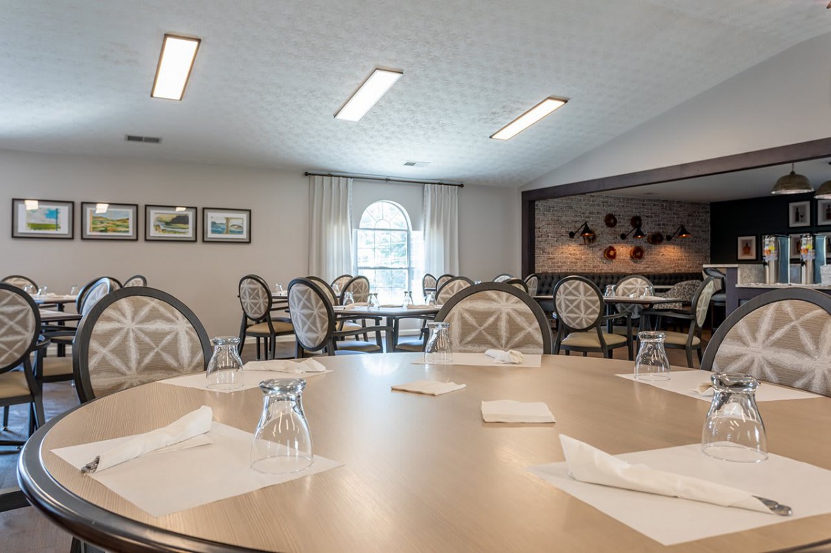 An elegantly arranged dining room with neatly set tables and classic decor.