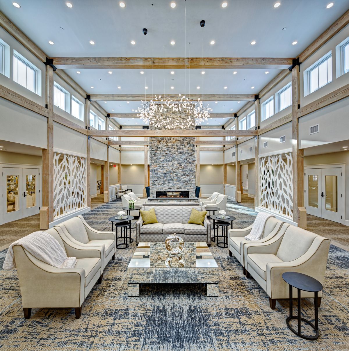 A luxurious hotel lobby with elegant furniture and a grand chandelier.
