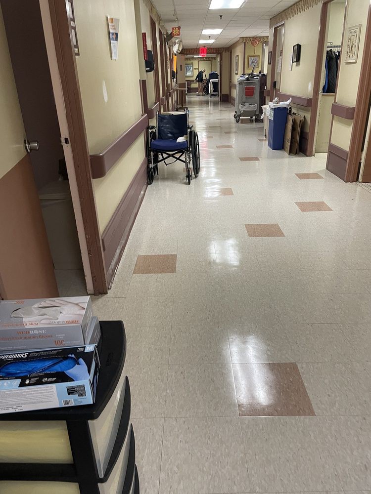 A hospital corridor with medical equipment and supplies along the sides.